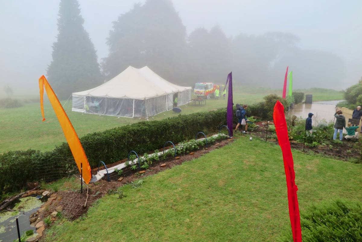 Rhiannon Phillips of Mountains Gourmet showing drip irrigation installed on the Planetary Health Precinct